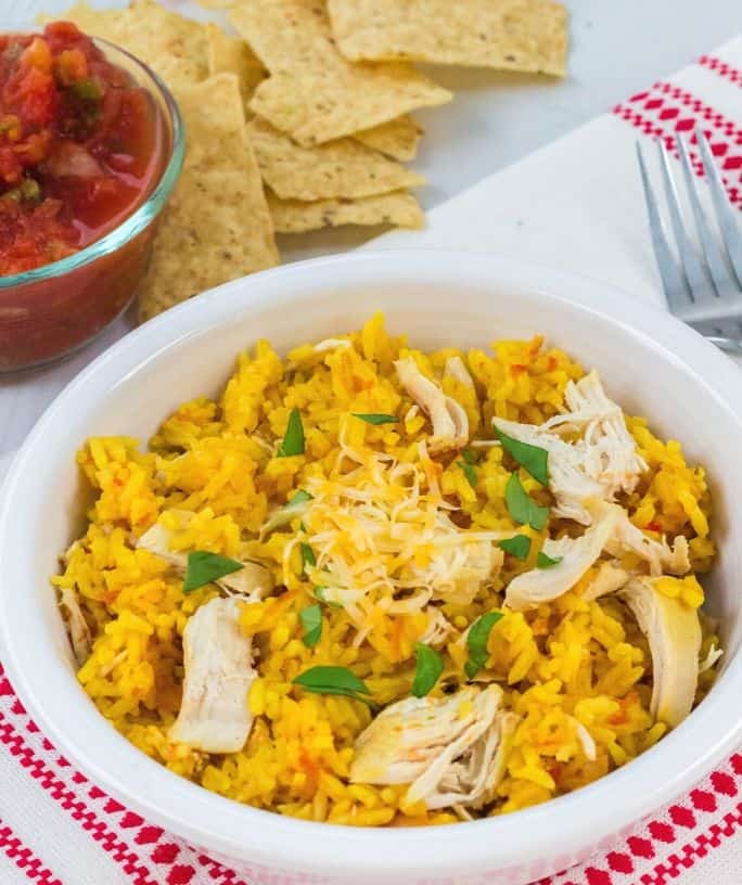 white bowl of arroz con pollo cooked in the pressure cooker