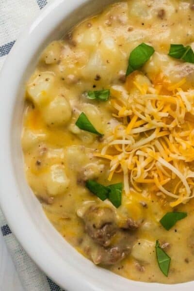 white bowl filled with the casserole of cheese, ground beef, and potatoes that was cooked in the Instant Pot