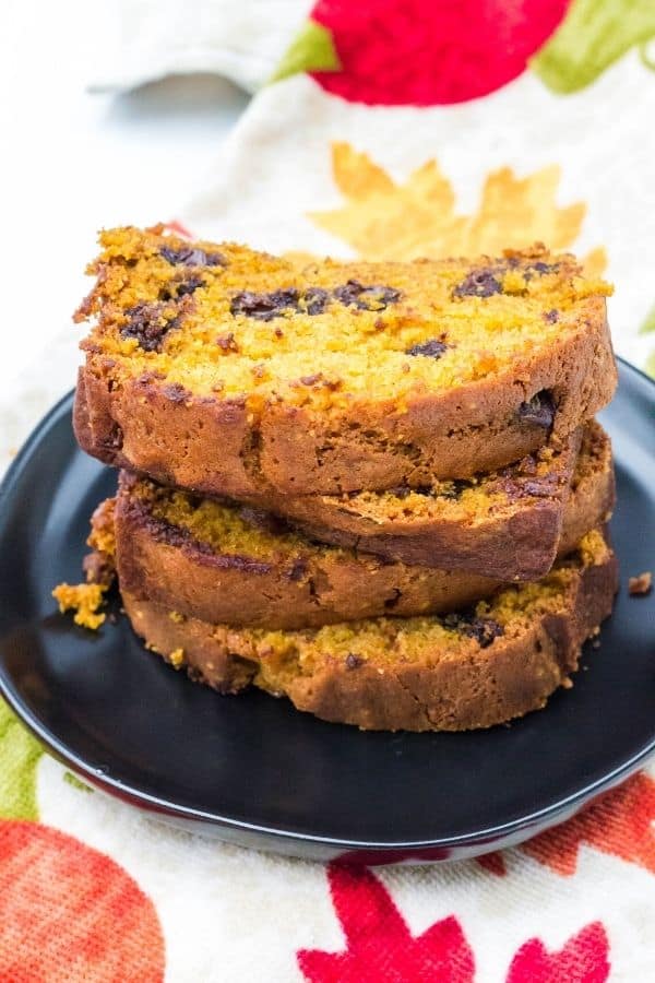 stack of pumpkin chocolate chip bread slices on a black plate