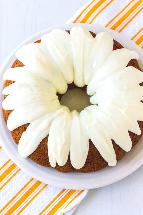 a whole pumpkin bundt cake on a white serving plate