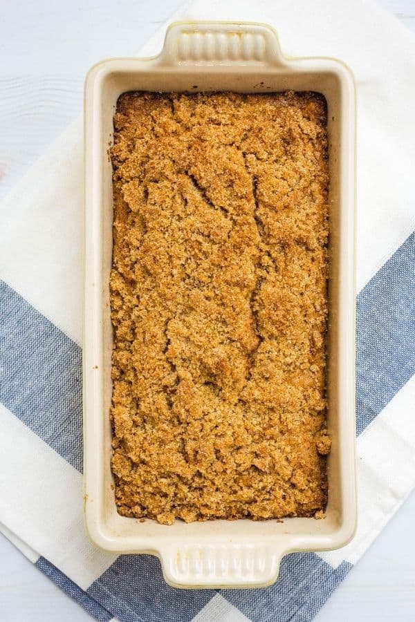 freshly baked loaf of pear bread topped with streusel, still in the pan