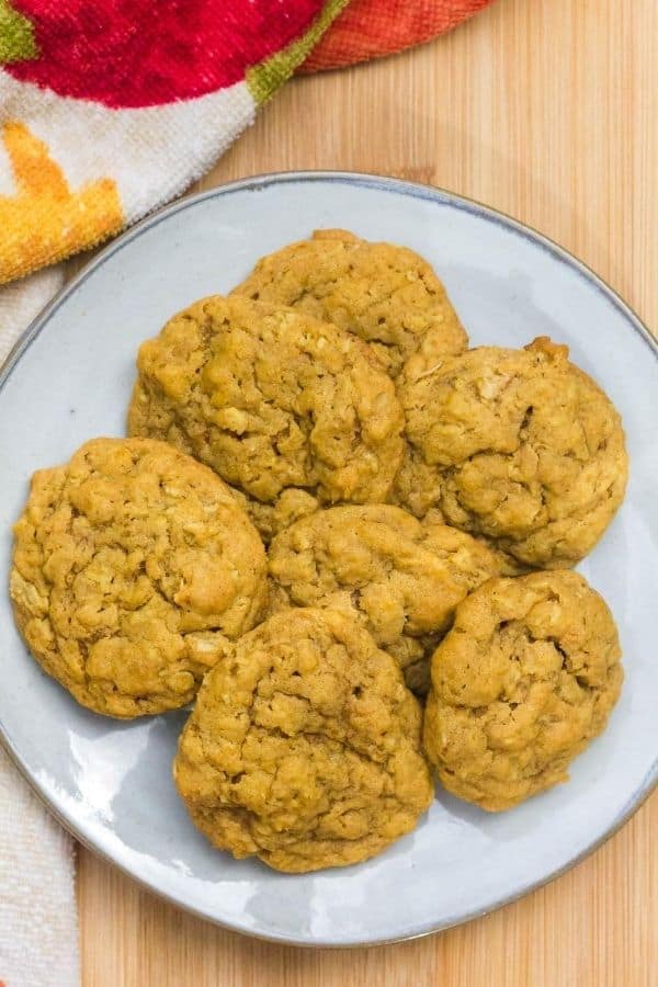white plate with several pumpkin oatmeal cookies on it