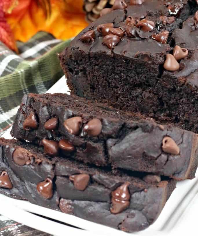 sliced loaf of double chocolate pumpkin bread on a white plate