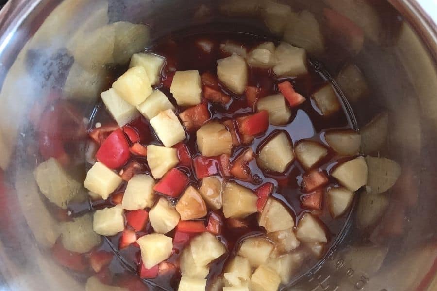 chicken, peppers, pineapple, and sauce in the Instant Pot for making Hawaiian chicken