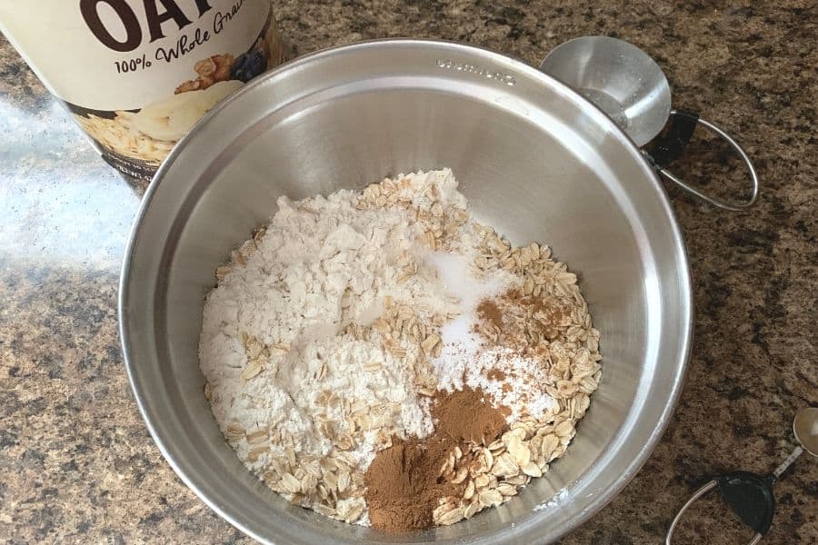 a bowl of dry ingredients for chewy oatmeal pumpkin cookies