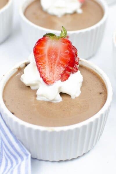 ramekin of Instant Pot chocolate custard topped with whipped cream and strawberries