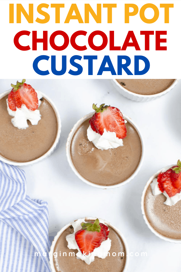 several custard cups filled with Instant Pot chocolate custard and topped with whipped cream and sliced strawberries
