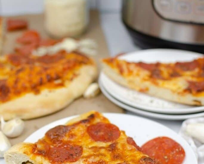 slices of pizza in front of an Instant Pot pressure cooker