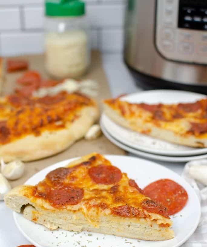 slices of pizza in front of an Instant Pot pressure cooker