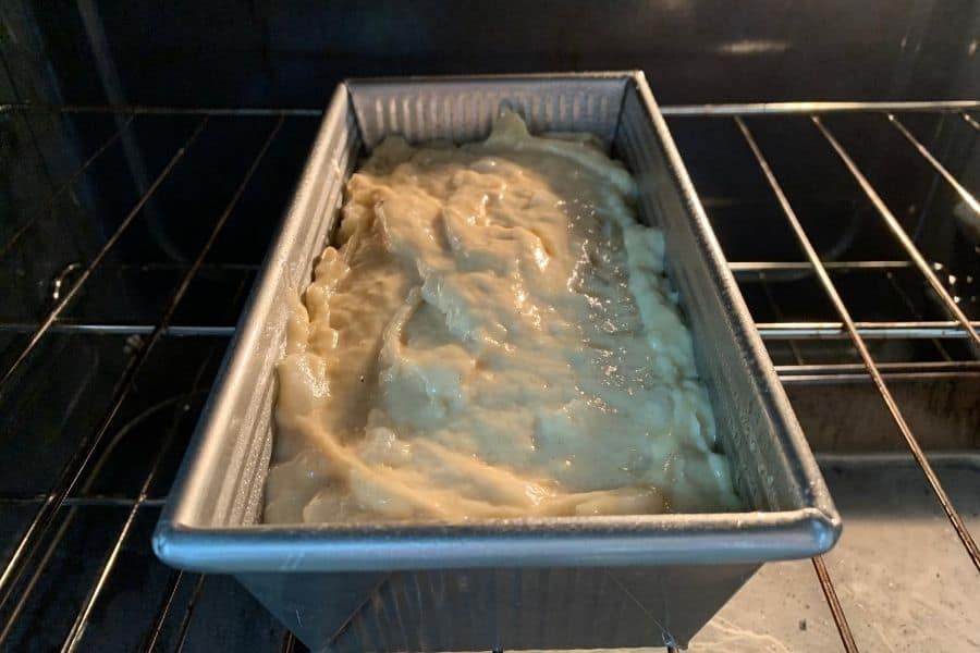 loaf pan filled with banana pear bread batter in the oven