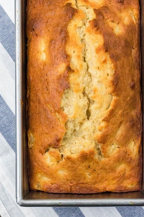 freshly baked loaf of banana pear bread still in the pan