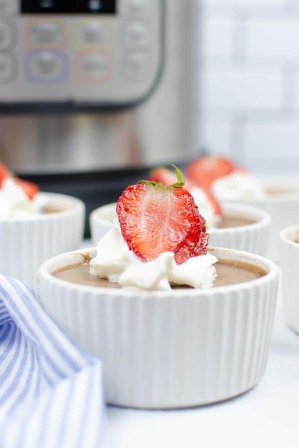 Instant Pot chocolate mousse topped with whipped cream and strawberries