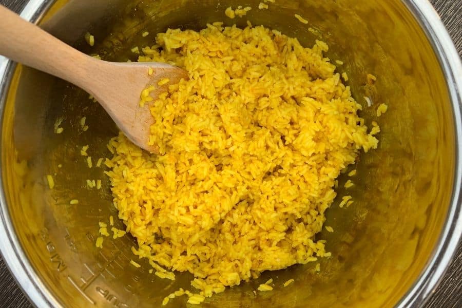 freshly cooked and fluffed yellow rice in the Instant Pot