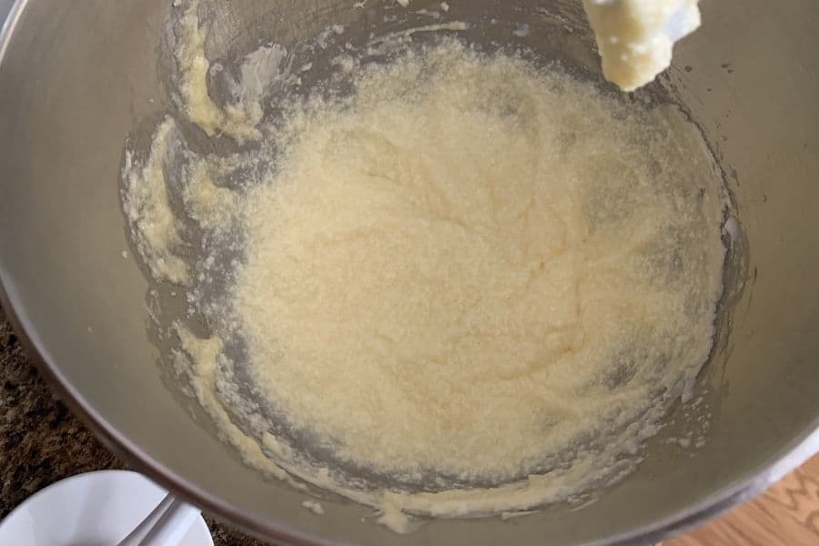 butter, sugar, egg, and sour cream mixed together for pistachio cookie batter