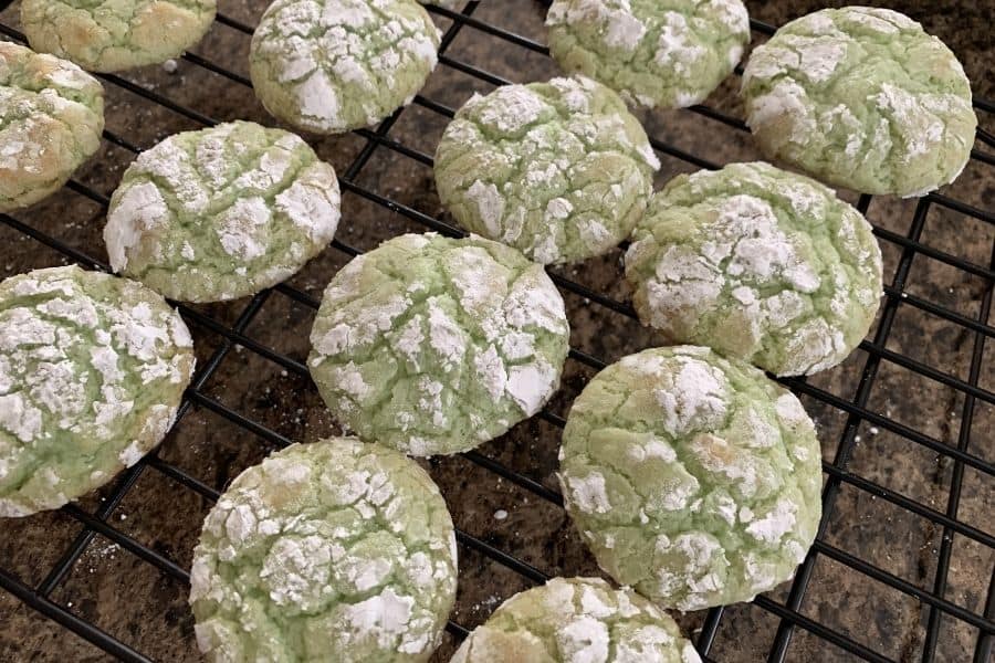 freshly baked pistachio crinkle cookies on a cooling rack