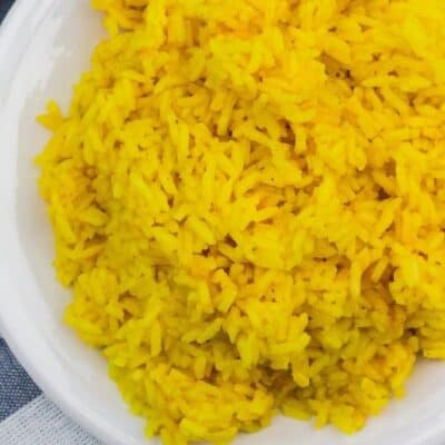 plate of yellow rice on a blue and white napkin