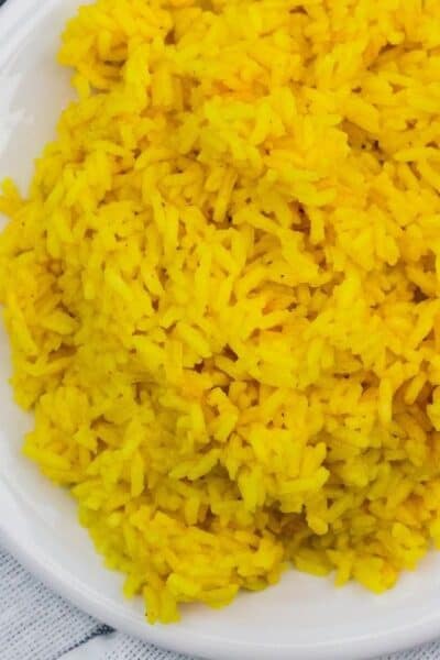 plate of yellow rice on a blue and white napkin