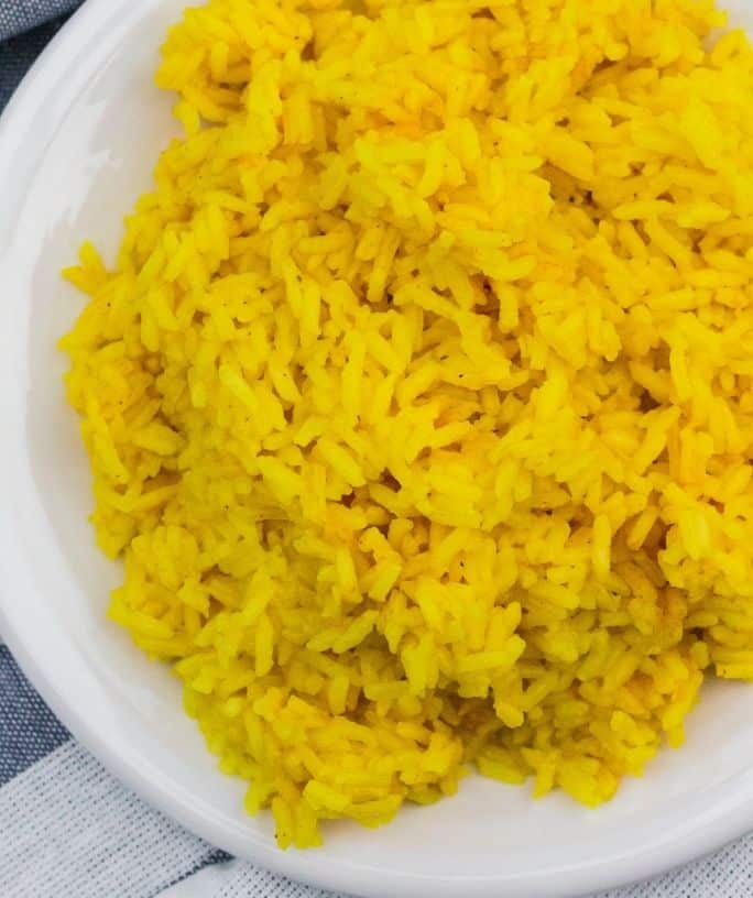 plate of yellow rice on a blue and white napkin