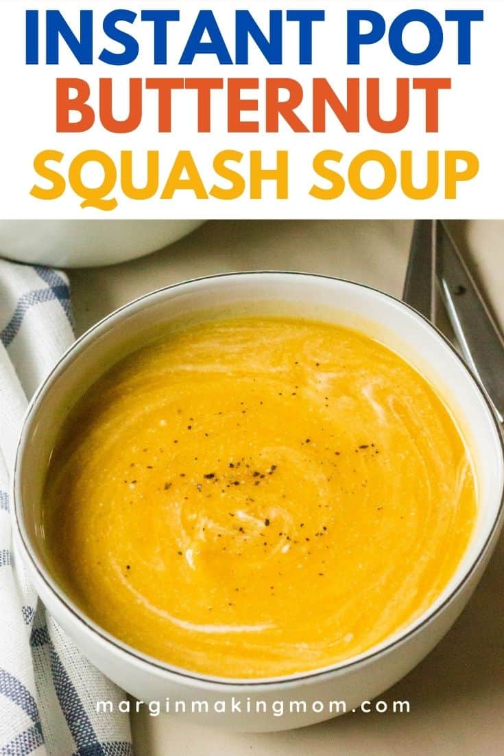 a cream-colored bowl filled with Instant Pot butternut squash and apple soup, with swirls of coconut milk and cracked pepper on top.