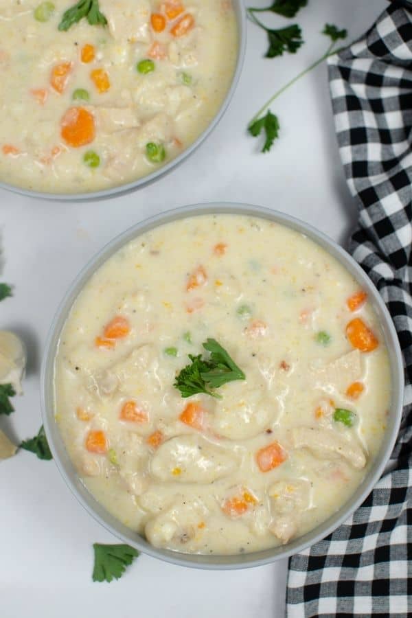 two bowls of chicken and dumplings made with canned biscuits and cooked in the Instant Pot pressure cooker