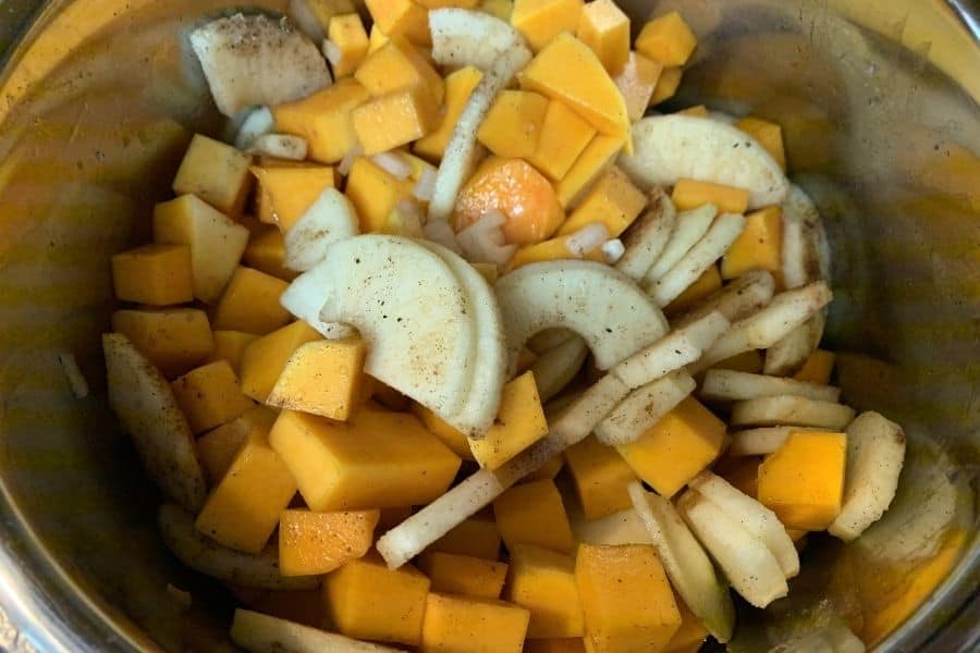 apples, butternut squash, and seasonings mixed in the Instant Pot for making soup