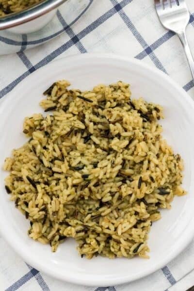 white plate of wild rice cooked in the pressure cooker, on a blue and white napkin