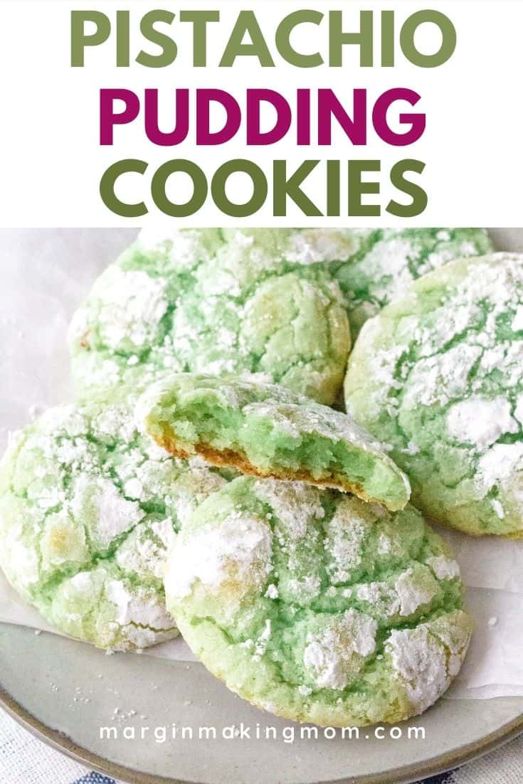 a plate full of green pistachio pudding cookies with powdered sugar