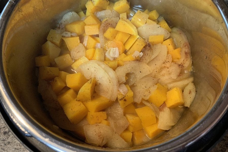 freshly cooked apples, butternut squash, and seasonings for squash soup, ready to be pureed.