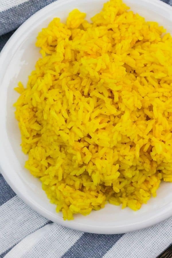 yellow rice from a package, freshly cooked in the Instant Pot and served on a white plate
