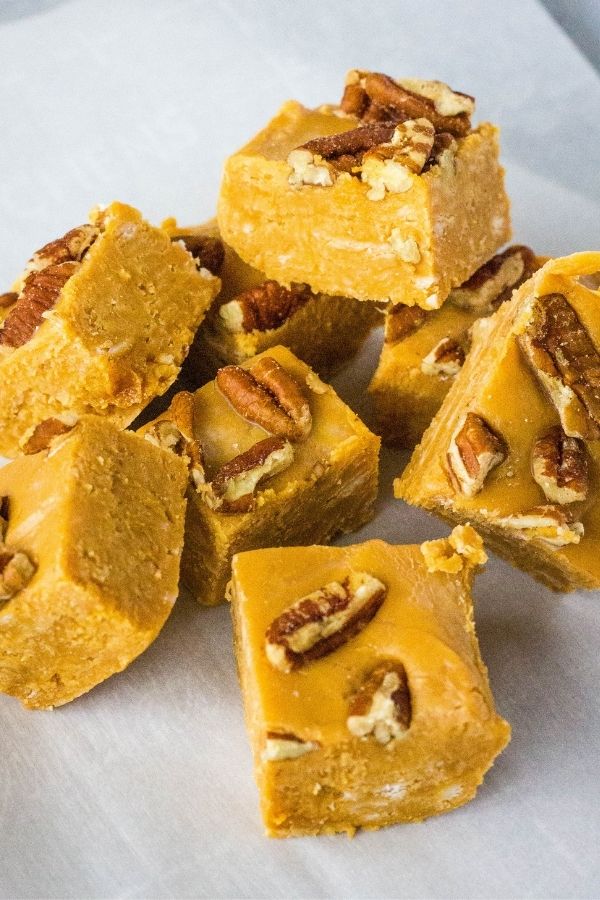 Pieces of dulce de leche caramel fudge with pecans pressed into the tops