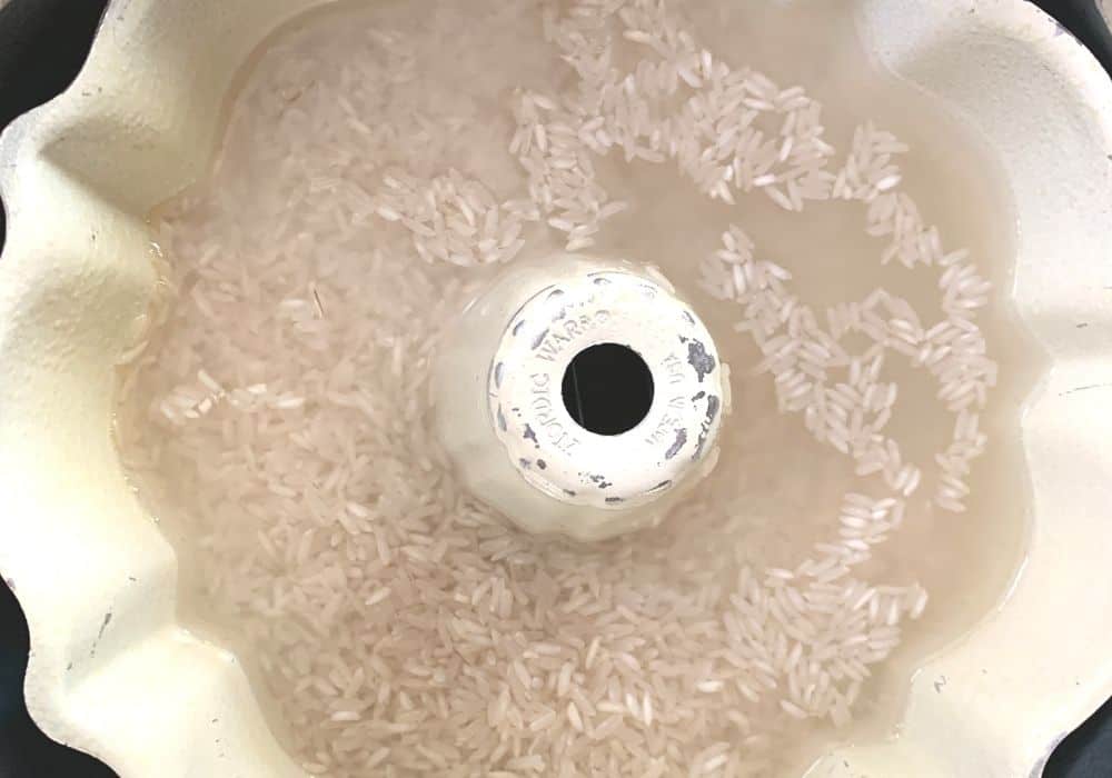 rice and water mixed in a bundt pan inside of the Instant Pot