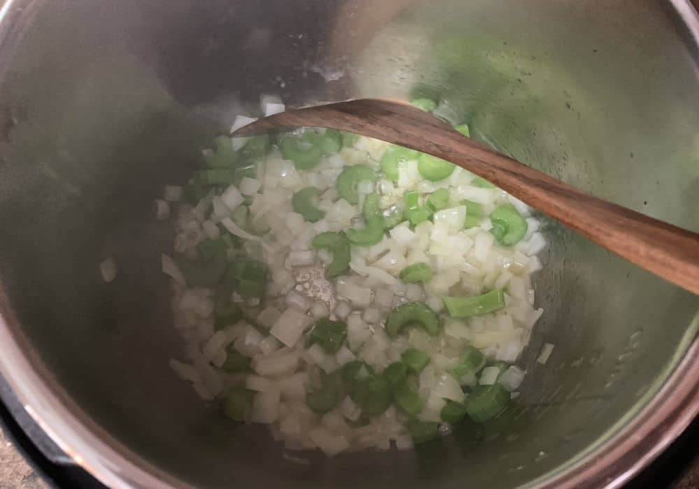 Onions and celery being sauteed in butter in the Instant Pot
