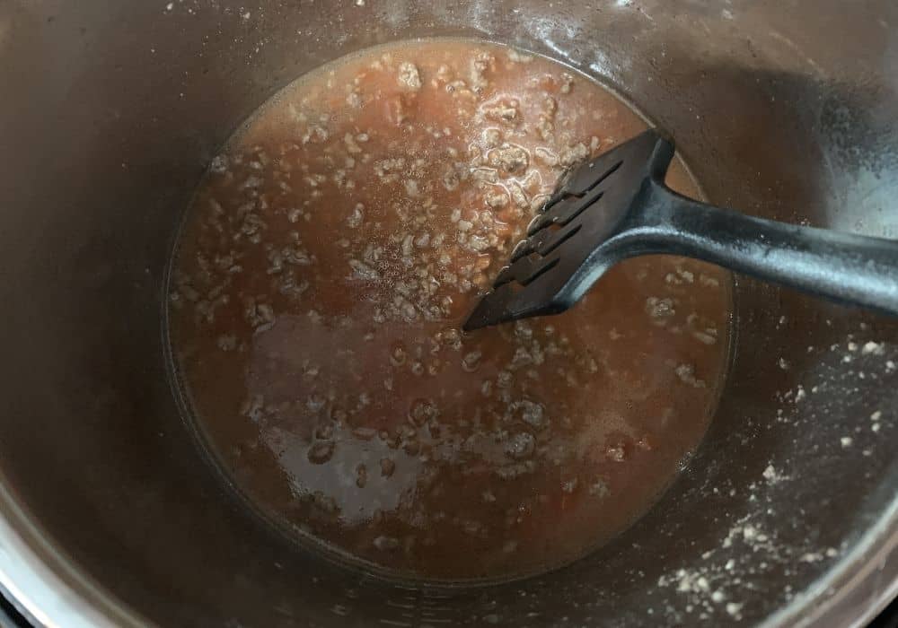 Ingredients for pressure cooker Cincinnati chili combined in the insert pot of the Instant Pot.