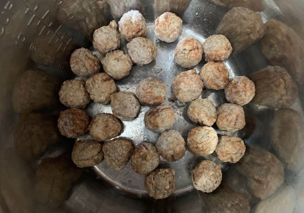 frozen meatballs in the insert pot of the Instant Pot