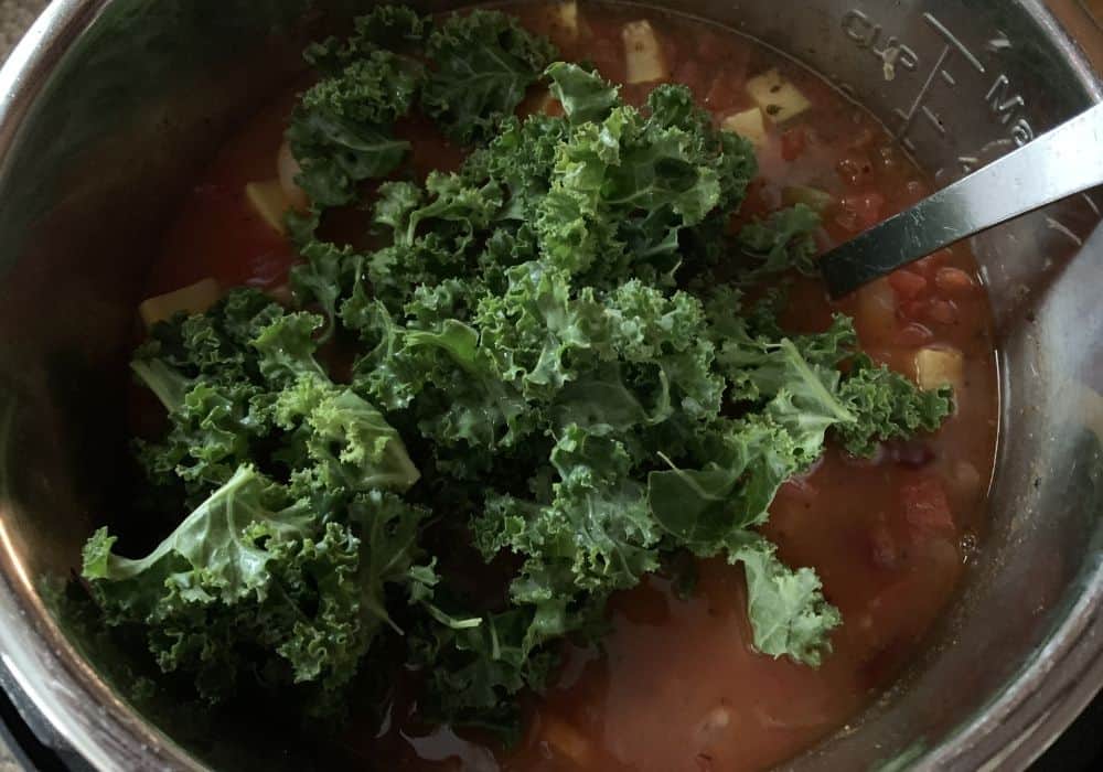 kale added into Instant Pot minestrone soup to wilt