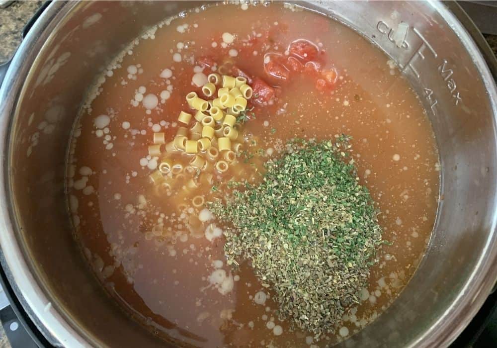 pasta, broth, tomatoes, and seasonings for Instant Pot pasta e fagioli