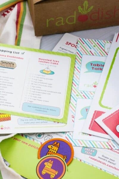 the printed materials from a Raddish Kids box are laid out in view.