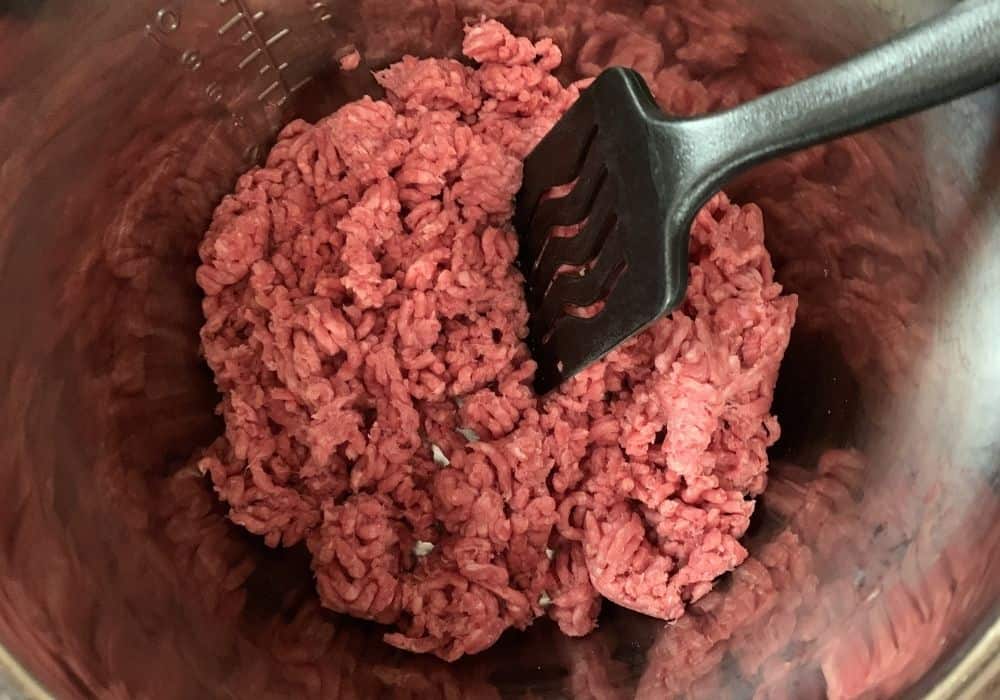 ground beef in the insert pot of the Instant Pot
