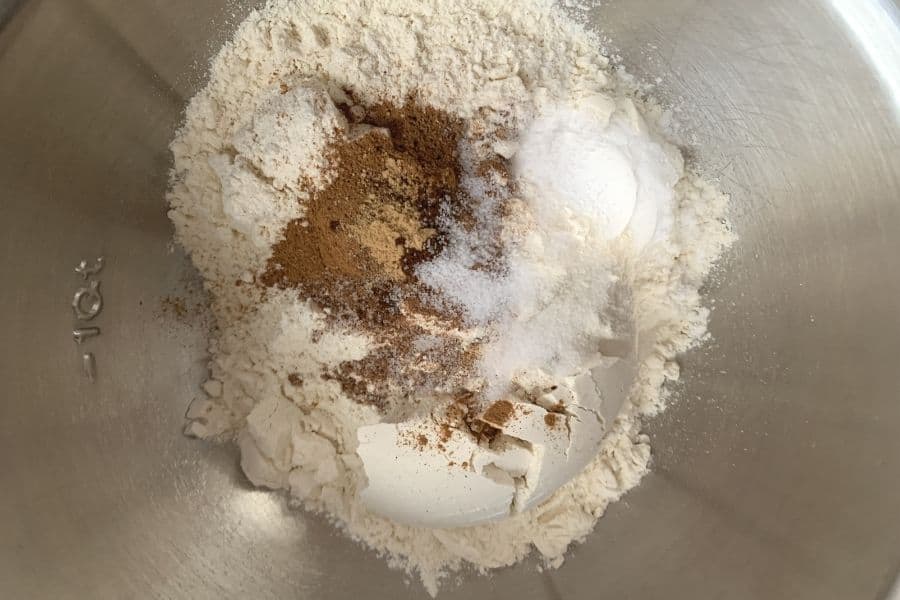 Dry ingredients for molasses cookies mixed into a metal bowl.