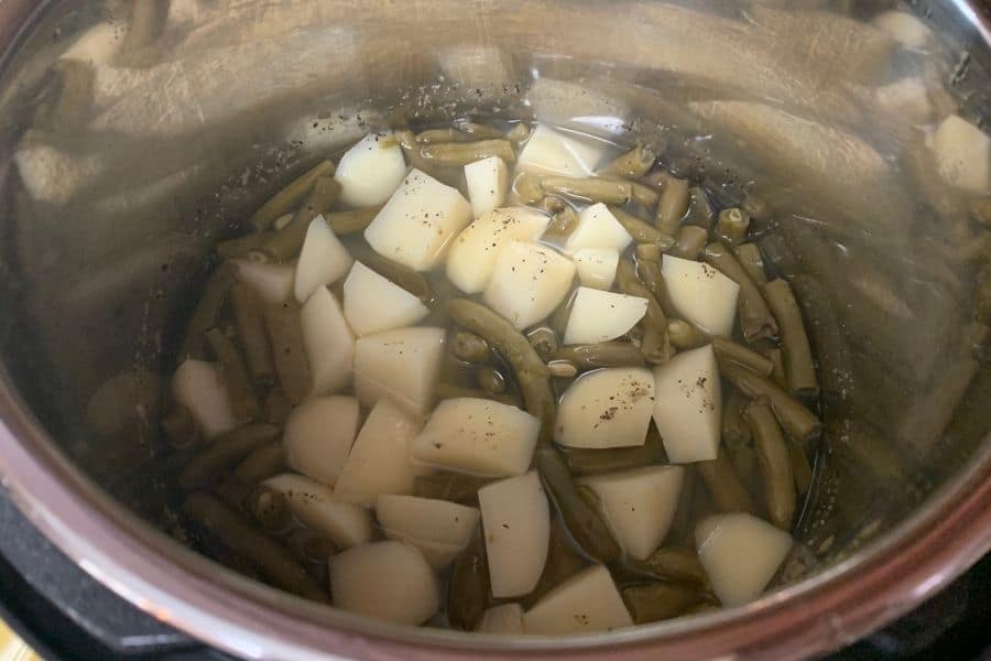 Freshly cooked green beans and potatoes in the insert pot of the Instant Pot, ready to be served.