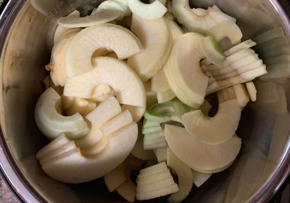sliced, peeled, and cored apples in the insert pot of the Instant Pot for making applesauce