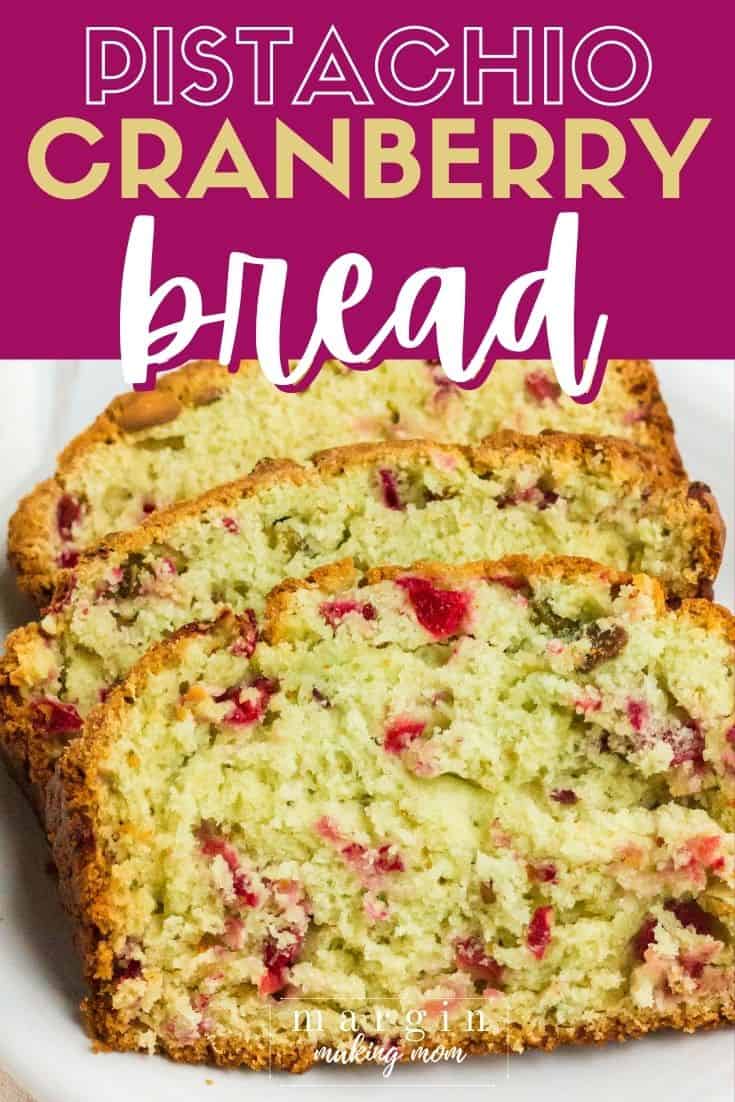 three slices of cranberry pistachio bread on a white plate