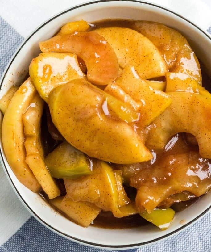 a white bowl of cinnamon apples that were cooked in the Instant Pot pressure cooker