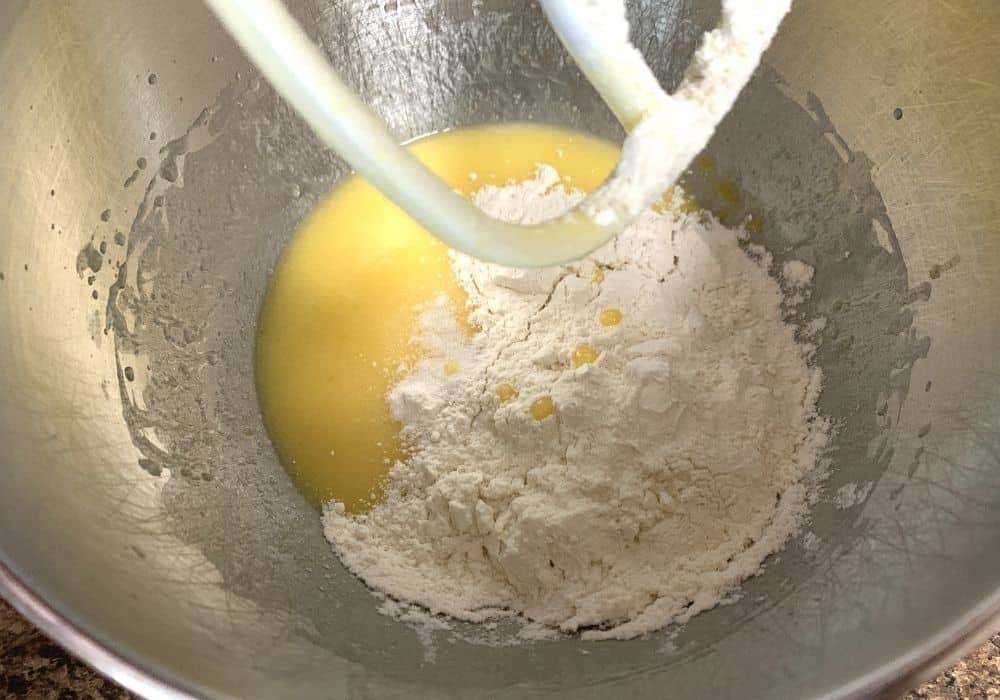 flour and salt added to eggs, sugar, butter, and extracts.