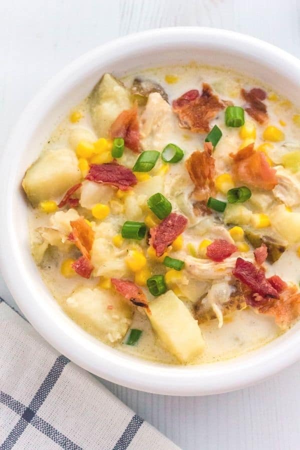 Potato corn chicken chowder cooked in the pressure cooker, served in a white bowl