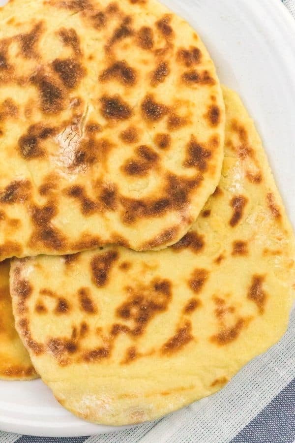 easy Instant Pot naan bread stacked on a plate