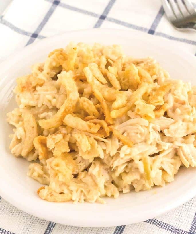 white plate of Instant Pot french onion chicken and rice