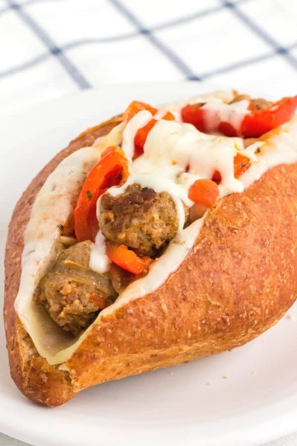 Instant Pot italian sausage and peppers sandwich on a white plate