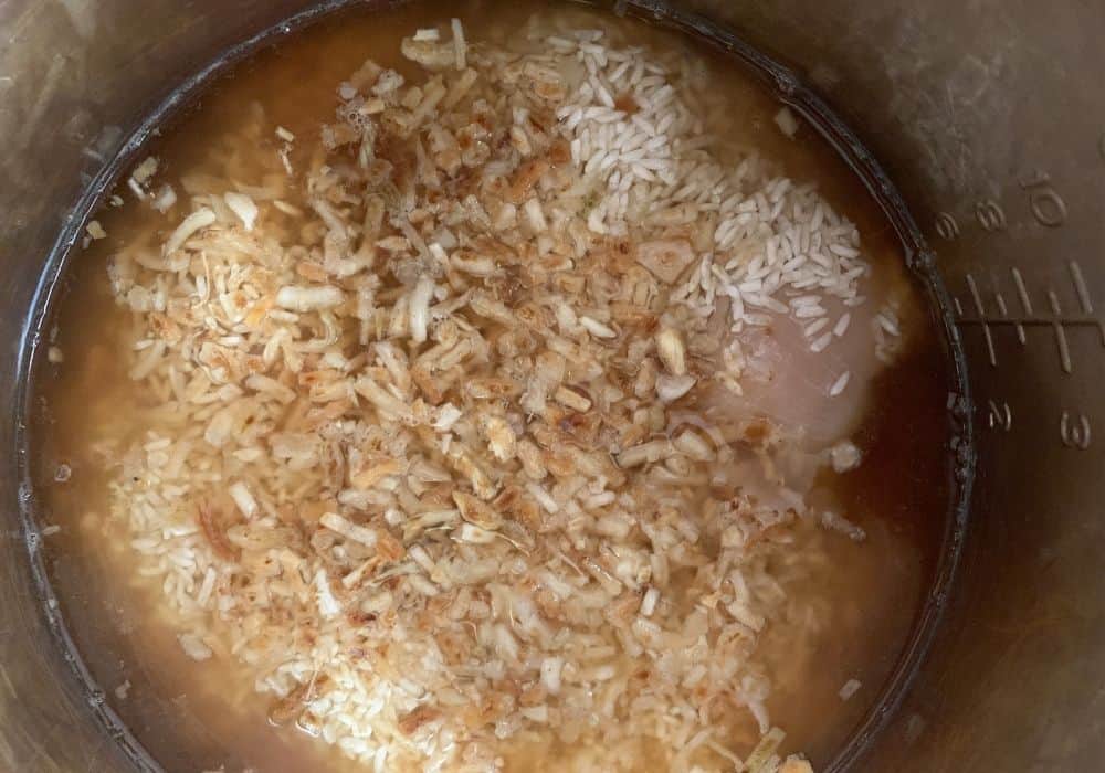 ingredients for french onion chicken and rice mixed together in the Instant Pot for cooking