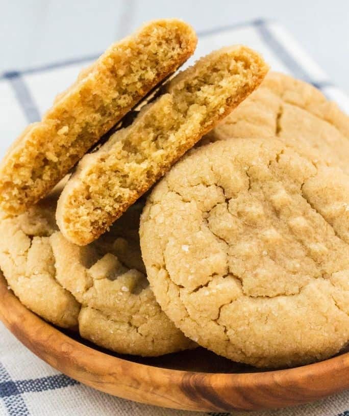several peanut butter cookies made with pancake mix on a wooden plate